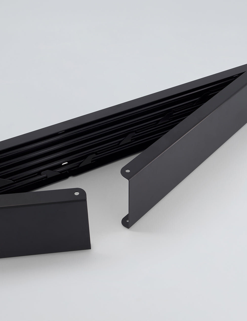 Black foldable drying rack mounted in laundry room