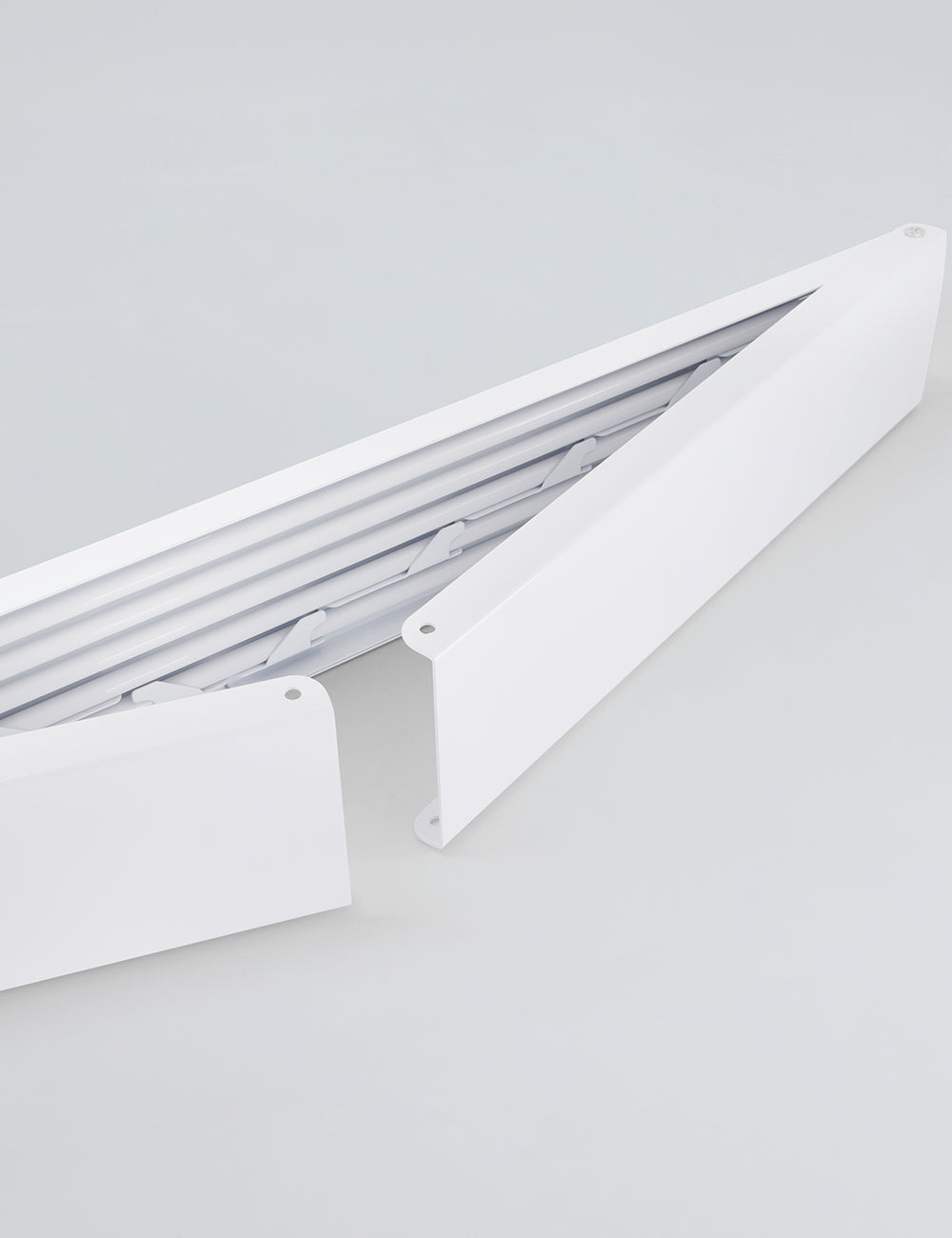 White foldable drying rack mounted in laundry room